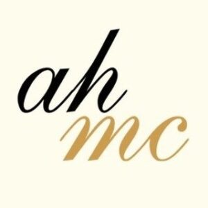 Al Harub Medical Centre AHMC initials logo in black and gold script, private medical and mental health centre in Hay Al Sarooj, Muscat