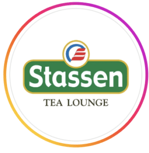 Circular logo for Stassen Tea Lounge featuring the Stassen brand name in white on green with a red and blue emblem, at Al Falaj Hotel, Al Hamriyah, Muscat