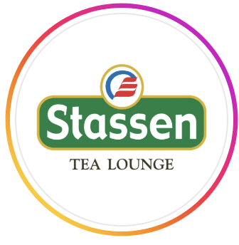 Circular logo for Stassen Tea Lounge featuring the Stassen brand name in white on green with a red and blue emblem, at Al Falaj Hotel, Al Hamriyah, Muscat