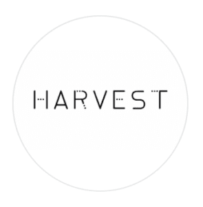 Circular white logo for Harvest restaurant with minimal geometric lettering, at W Muscat hotel, Shatti Al Qurum, Muscat