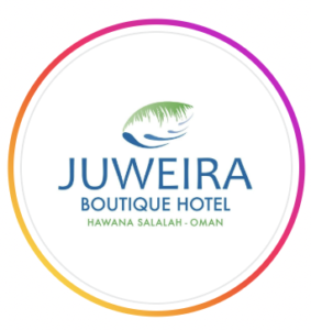 Circular logo for Juweira Boutique Hotel featuring blue lettering and a green palm leaf illustration, at Hawana Salalah Marina, Salalah, Oman