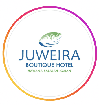 Circular logo for Juweira Boutique Hotel featuring blue lettering and a green palm leaf illustration, at Hawana Salalah Marina, Salalah, Oman