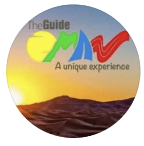 Circular logo for The Guide Oman featuring a desert sunset landscape with colourful Oman lettering and the tagline A Unique Experience