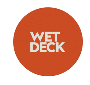 Circular orange logo for WET Deck with bold cream lettering, the pool bar and deck at W Muscat, Shatti Al Qurum, Muscat