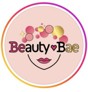 Circular pink and gold logo for Beauty Bae featuring playful bubble and lips illustration with a pink and orange gradient border, an online beauty and cosmetics retailer